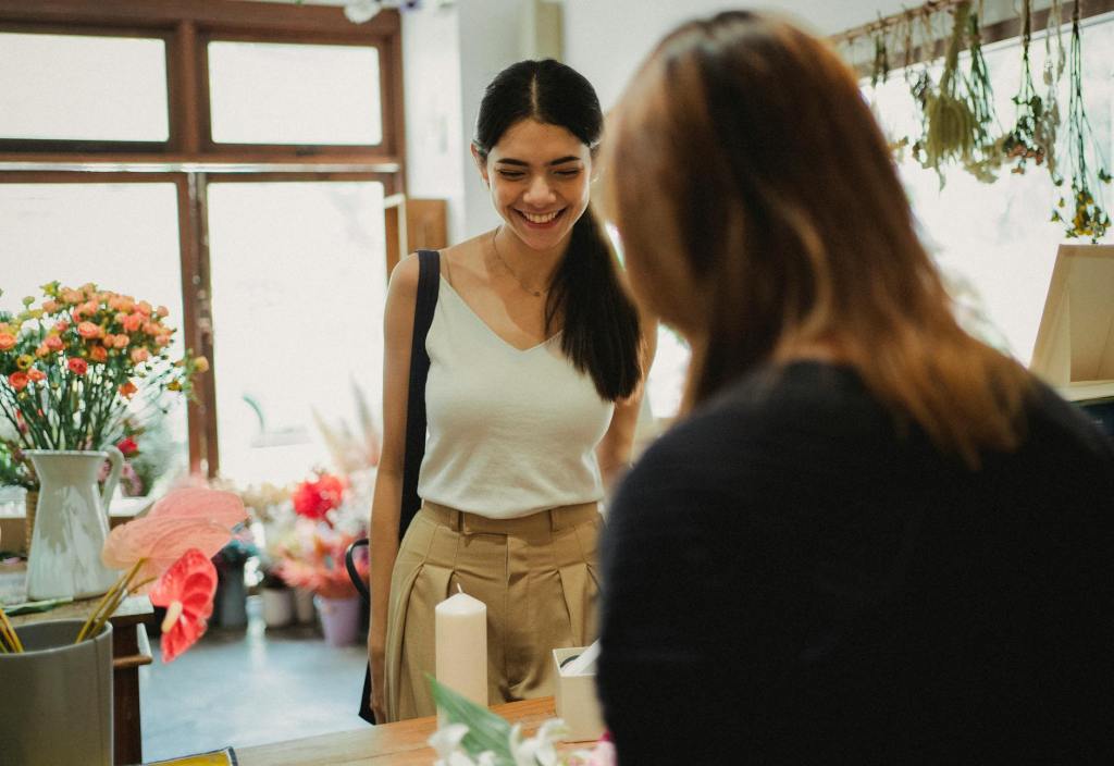 happy woman visiting floral shop and buying bouquet